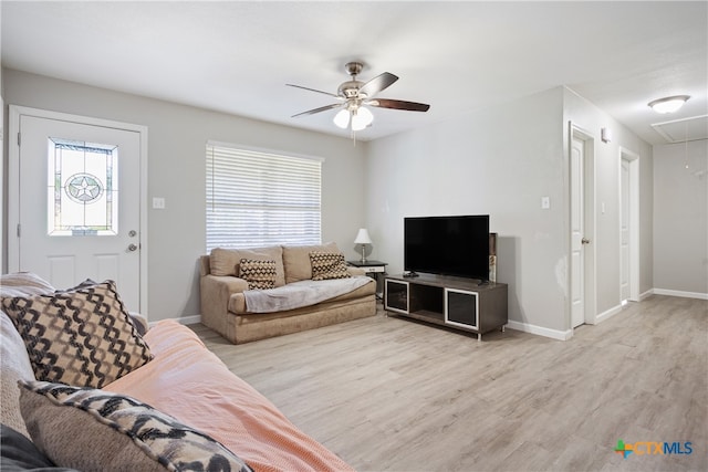 living room with plenty of natural light, ceiling fan, and light hardwood / wood-style flooring