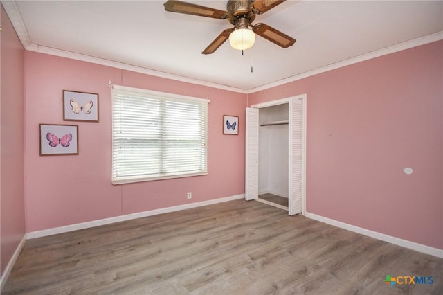 127 S Mesquite Dr, Victoria, TX 77905 - unfurnished bedroom featuring crown molding, wood finished floors, baseboards, a closet, and a ceiling fan