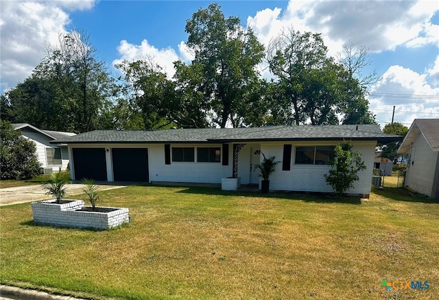 single story home featuring a garage and a front lawn