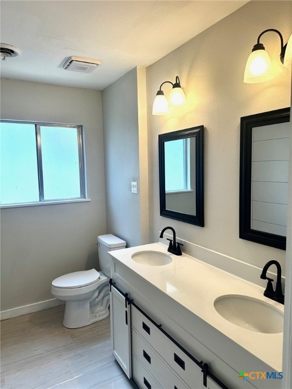 bathroom featuring hardwood / wood-style floors, vanity, and toilet