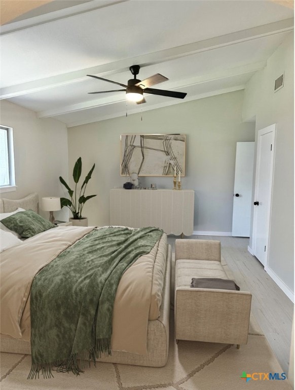 bedroom featuring ceiling fan, light hardwood / wood-style flooring, and beamed ceiling