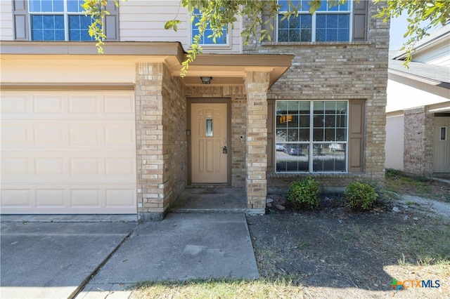 view of exterior entry with a garage