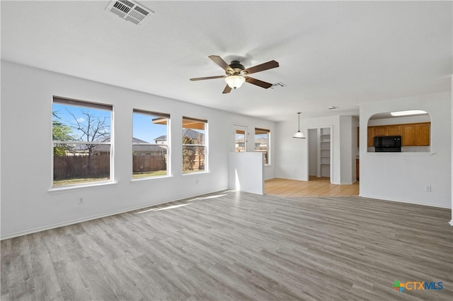 unfurnished living room with light hardwood / wood-style flooring and ceiling fan