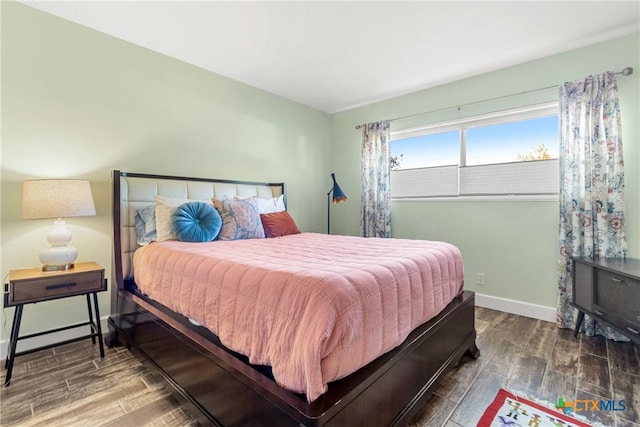 bedroom with dark wood-type flooring