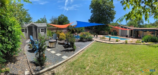 view of yard with a fenced in pool and a storage unit