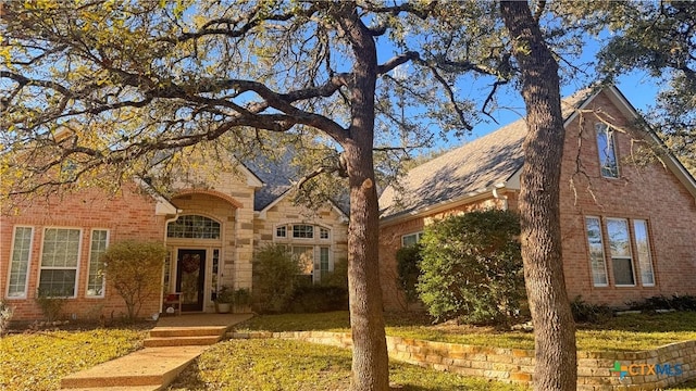 traditional home with stone siding and brick siding