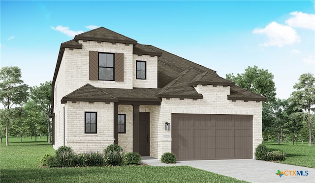 view of front of home featuring a front yard and a garage