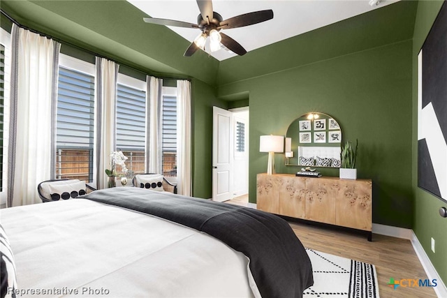 bedroom with hardwood / wood-style flooring and ceiling fan