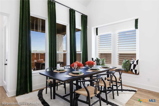 dining space with light hardwood / wood-style flooring