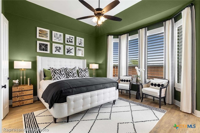 bedroom with ceiling fan and light wood-type flooring