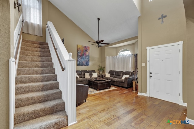 interior space featuring hardwood / wood-style floors, ceiling fan, and high vaulted ceiling