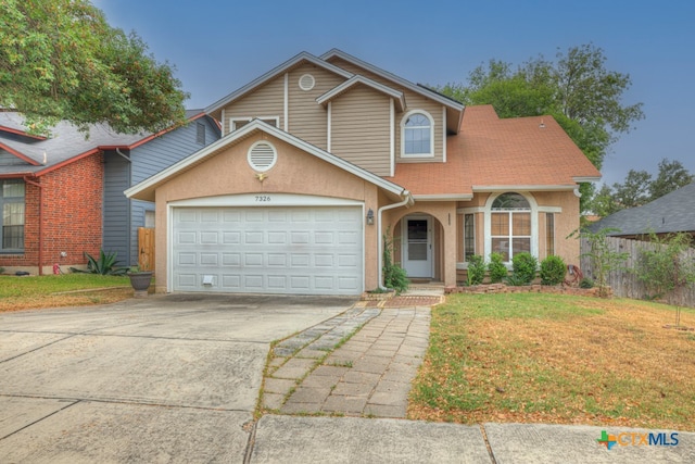 front facade with a garage and a front yard