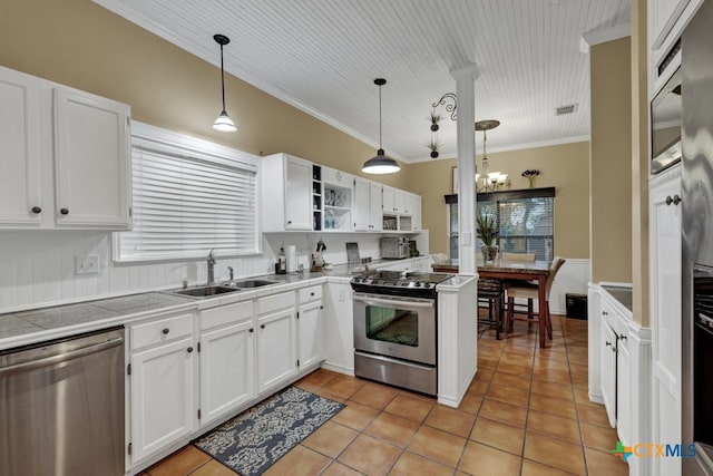 kitchen with stainless steel appliances, white cabinets, pendant lighting, and ornamental molding