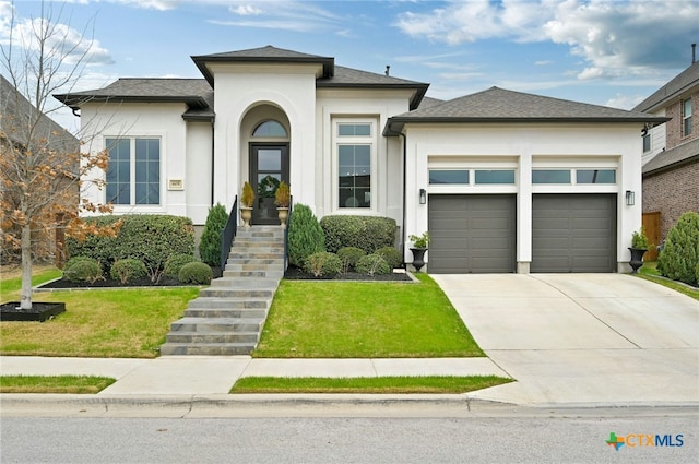 prairie-style house with a garage and a front yard