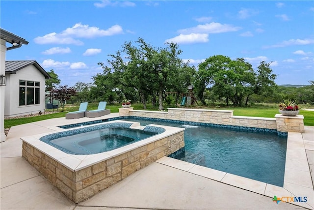 outdoor pool with a patio area and an in ground hot tub