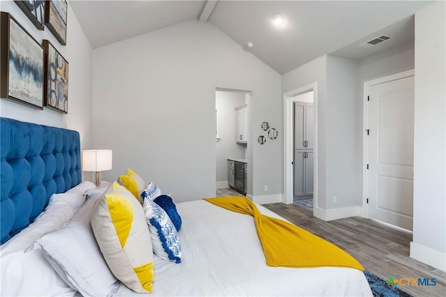 bedroom with visible vents, vaulted ceiling with beams, baseboards, and wood finished floors