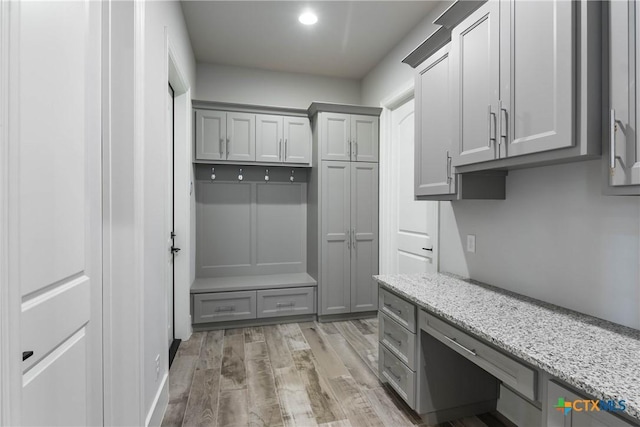 mudroom with light wood-type flooring and built in study area