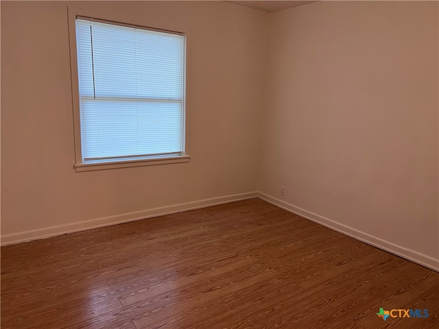 empty room with wood-type flooring