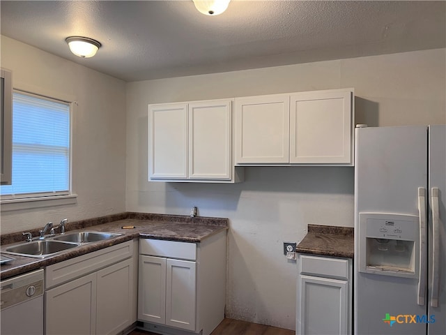 kitchen featuring white cabinetry, sink, hardwood / wood-style floors, dishwasher, and fridge with ice dispenser