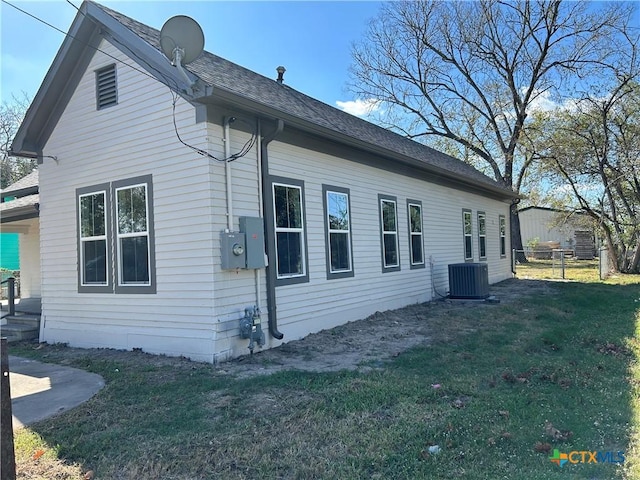 view of home's exterior with a yard and central AC