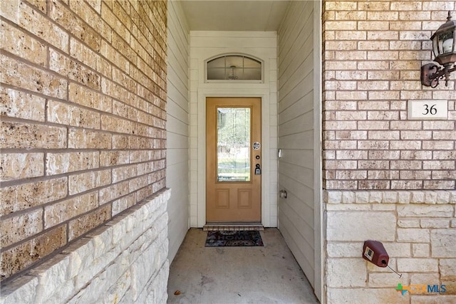 entrance to property with brick siding