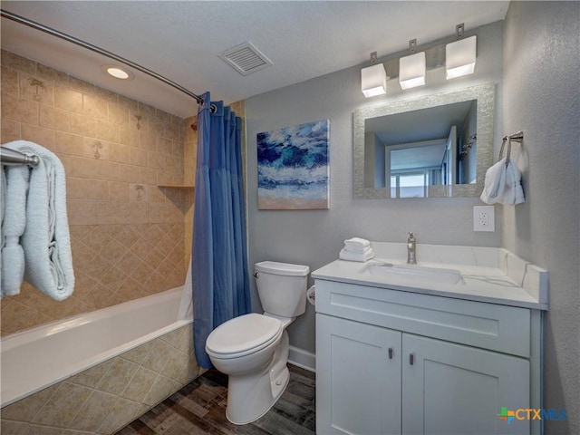 6021 State Highway 361 Unit 108, Port Aransas, TX 78373 - bathroom with toilet, wood finished floors, vanity, baseboards, and tiled shower / bath