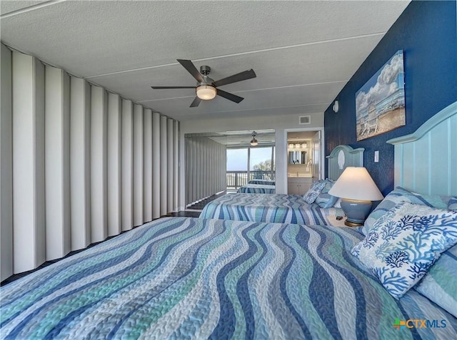 6021 State Highway 361 Unit 108, Port Aransas, TX 78373 - bedroom with a textured ceiling, a ceiling fan, and access to exterior