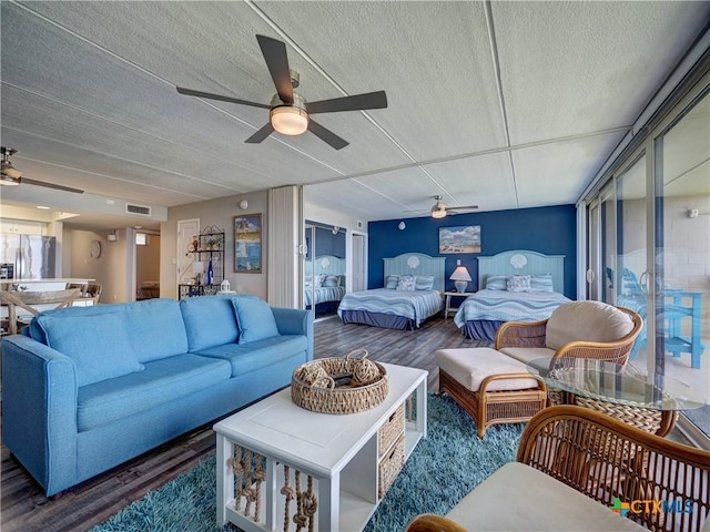 6021 State Highway 361 Unit 108, Port Aransas, TX 78373 - living room with a ceiling fan, wood finished floors, and a textured ceiling
