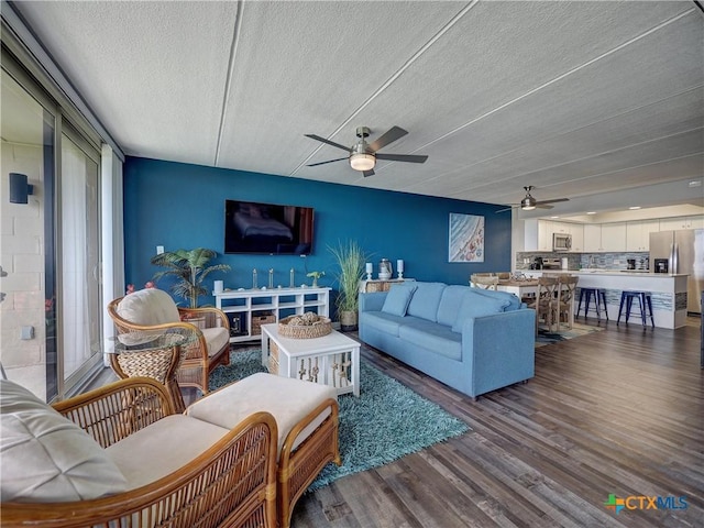 6021 State Highway 361 Unit 108, Port Aransas, TX 78373 - living area with ceiling fan, a textured ceiling, and wood finished floors