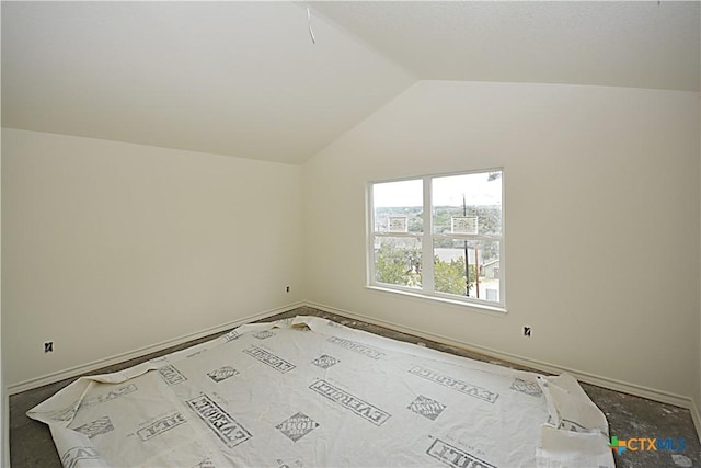 unfurnished room with lofted ceiling