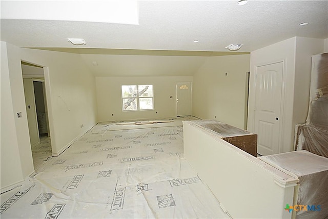 interior space featuring lofted ceiling and a textured ceiling