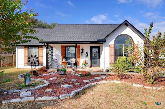 single story home with a porch and a front yard