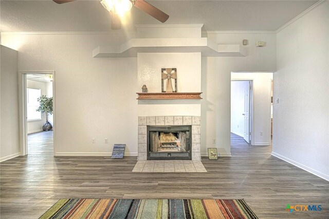 204 James Loop, Killeen, TX 76542 - unfurnished living room featuring a ceiling fan, wood finished floors, crown molding, and a tiled fireplace