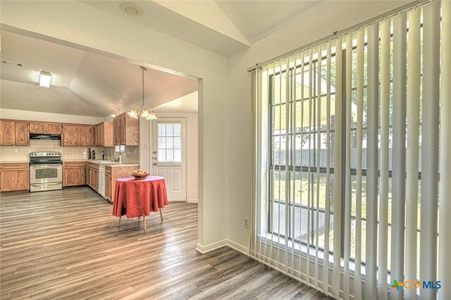 204 James Loop, Killeen, TX 76542 - kitchen featuring stainless steel range with electric stovetop, vaulted ceiling, under cabinet range hood, light countertops, and a chandelier