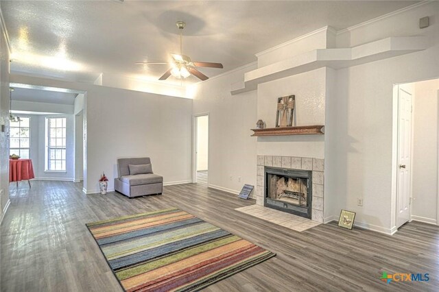 204 James Loop, Killeen, TX 76542 - living area with wood finished floors, ceiling fan, a fireplace, and crown molding