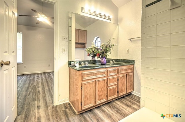 204 James Loop, Killeen, TX 76542 - bathroom with wood finished floors, a ceiling fan, double vanity, baseboards, and lofted ceiling
