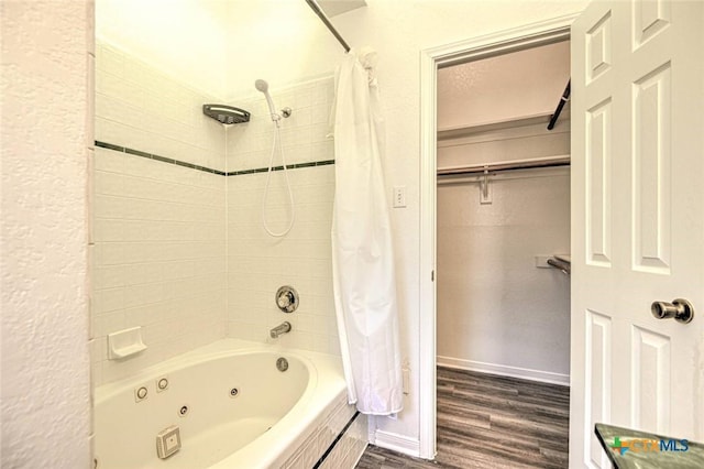 204 James Loop, Killeen, TX 76542 - bathroom featuring wood finished floors, a combined bath / shower with jetted tub, and baseboards