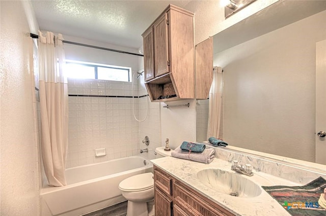 204 James Loop, Killeen, TX 76542 - full bath with shower / tub combo with curtain, vanity, toilet, a textured wall, and a textured ceiling