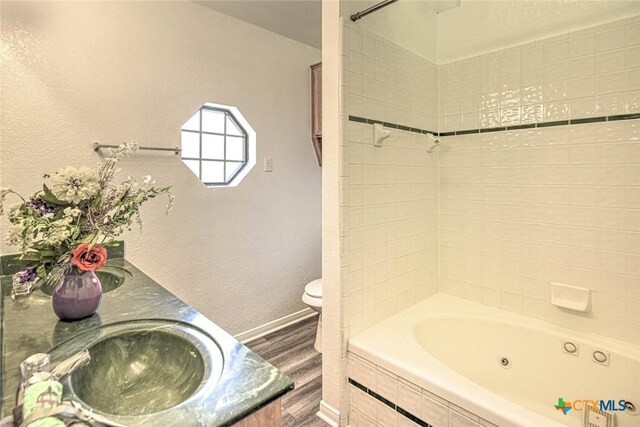 204 James Loop, Killeen, TX 76542 - full bathroom with wood finished floors, double vanity, and a combined bath / shower with jetted tub