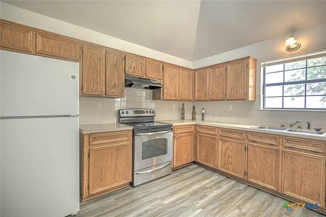 204 James Loop, Killeen, TX 76542 - kitchen with freestanding refrigerator, stainless steel electric stove, under cabinet range hood, a sink, and light countertops