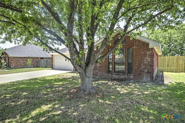 204 James Loop, Killeen, TX 76542 - obstructed view of property featuring driveway, brick siding, and a garage
