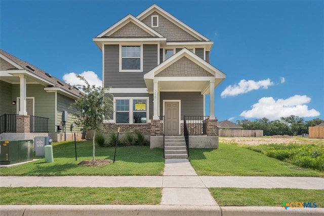 craftsman-style home with covered porch and a front yard