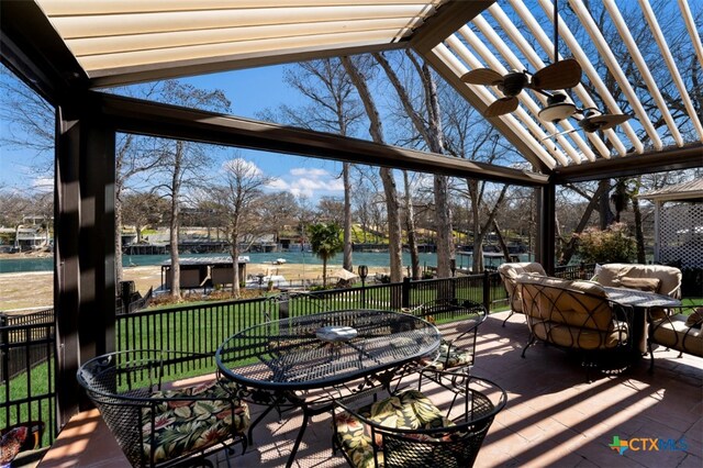 view of patio / terrace with outdoor dining area and a water view