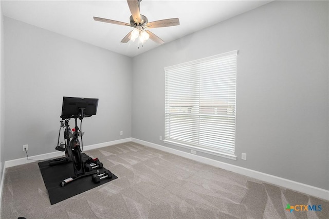 exercise area featuring carpet floors and ceiling fan