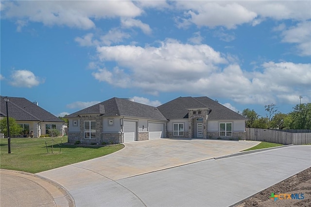 116 Vista De Luna Ln, Belton, TX 76513 - view of front facade featuring a front yard, stone siding, a garage, fence, and driveway