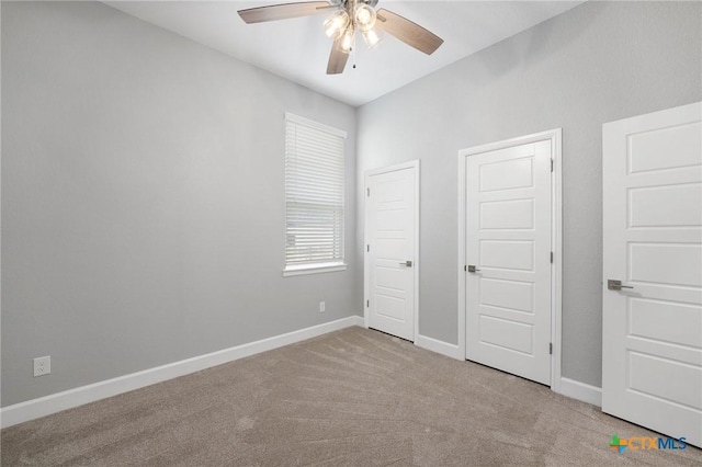 unfurnished bedroom featuring light carpet and ceiling fan