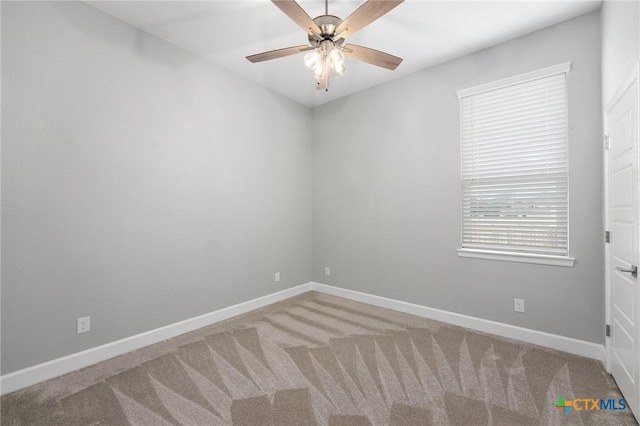 carpeted empty room featuring ceiling fan