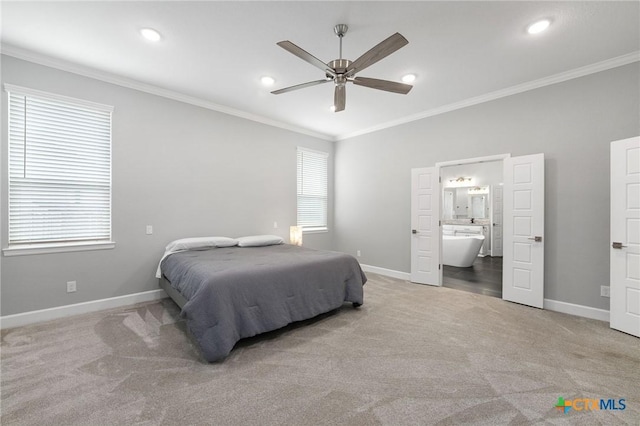 carpeted bedroom with ornamental molding, ensuite bathroom, and multiple windows