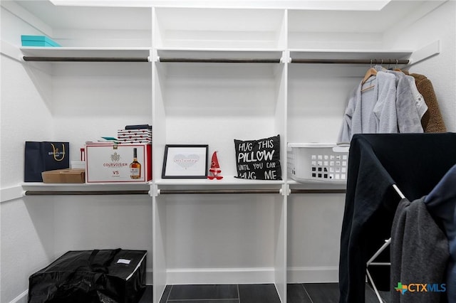 spacious closet with dark tile patterned flooring