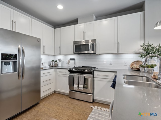 kitchen with white cabinets, stainless steel appliances, and sink